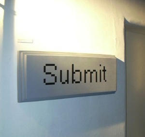 large button reading Submit mounted on the wall